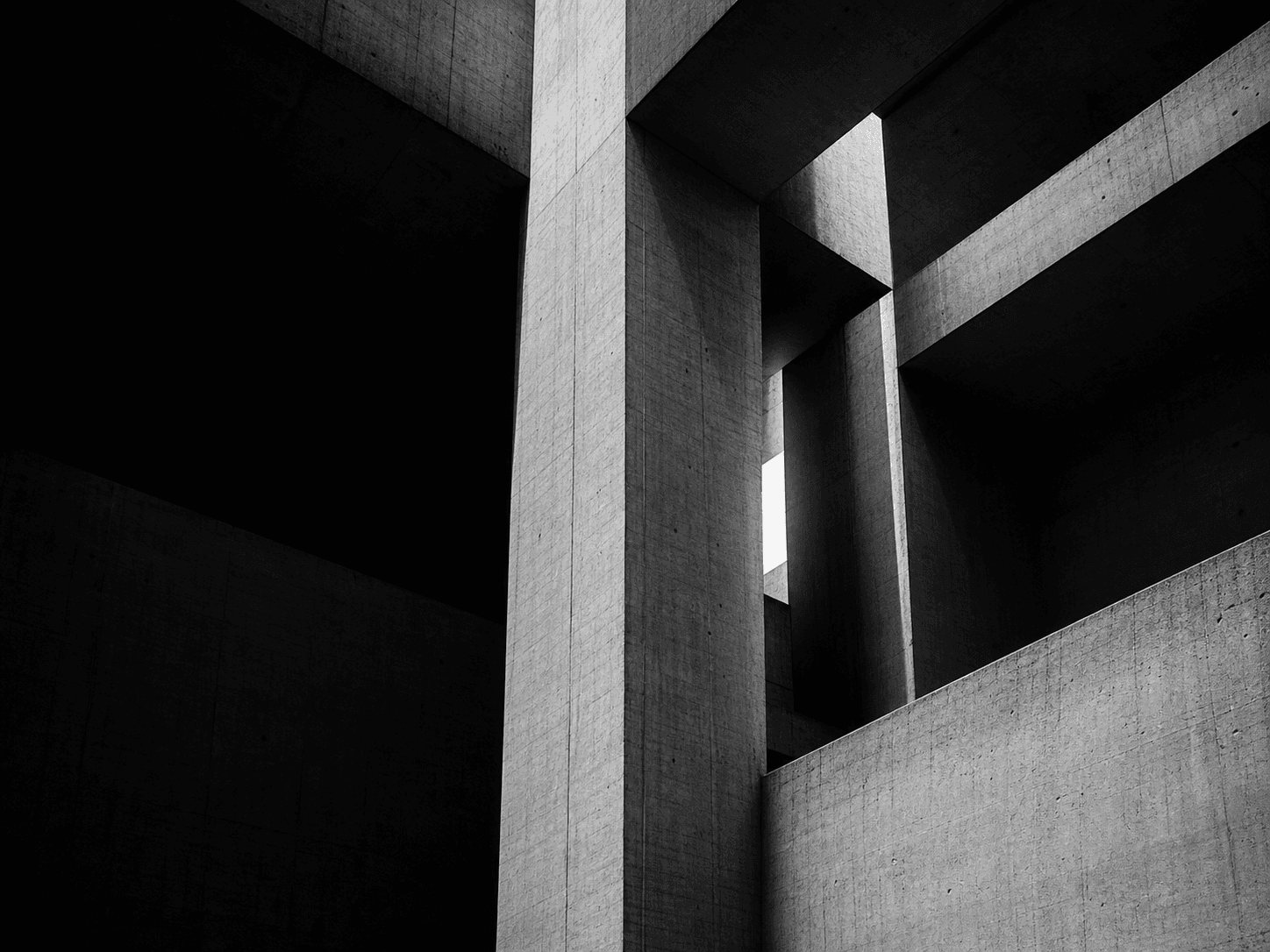 Monumental brutalist concrete architecture in dramatic black and white light