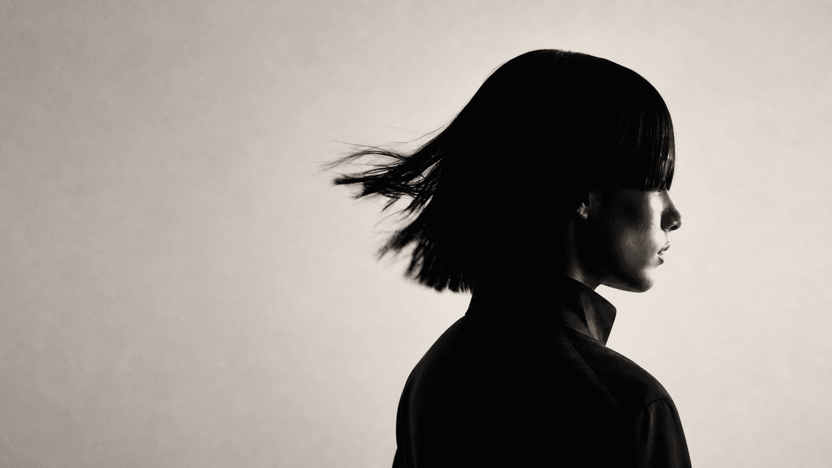 Monochrome profile of a woman with a moving bob haircut